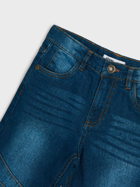 Close-up of blue denim jeans on a light gray background