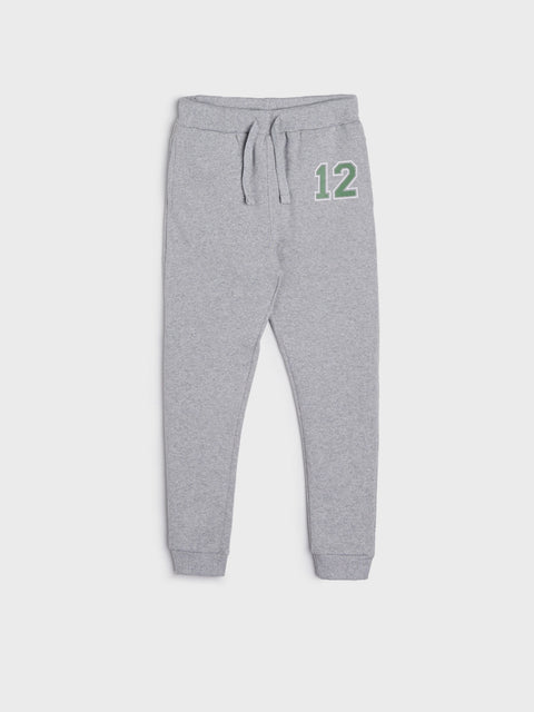 Gray sweatpants with a green number 12 on a white background