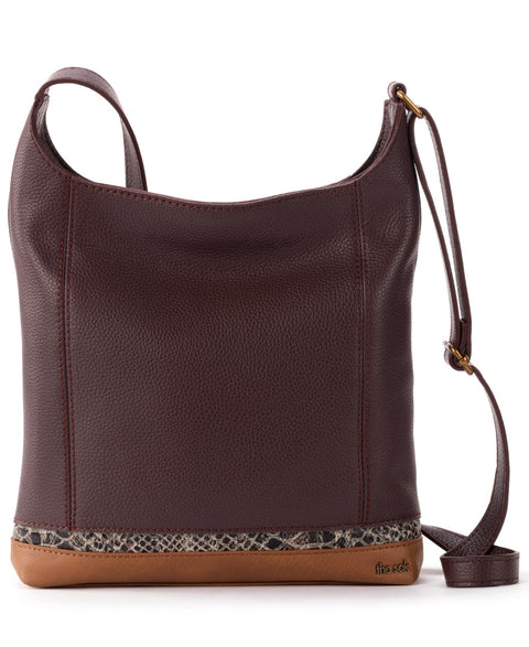 Brown leather handbag with a patterned bottom section on a white background