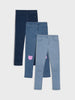 Three pairs of jeans in different shades on a light gray background