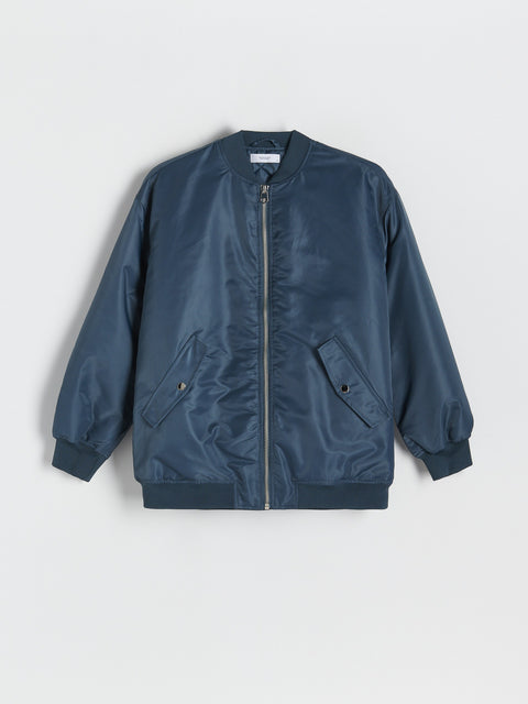 Blue bomber jacket on a light gray background