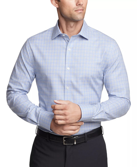 Man wearing a light blue checkered dress shirt with black pants on a white background