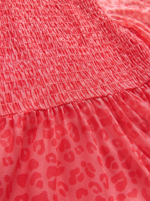 Close-up of a red dress with a textured pattern