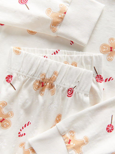 White fabric with gingerbread man and candy cane pattern