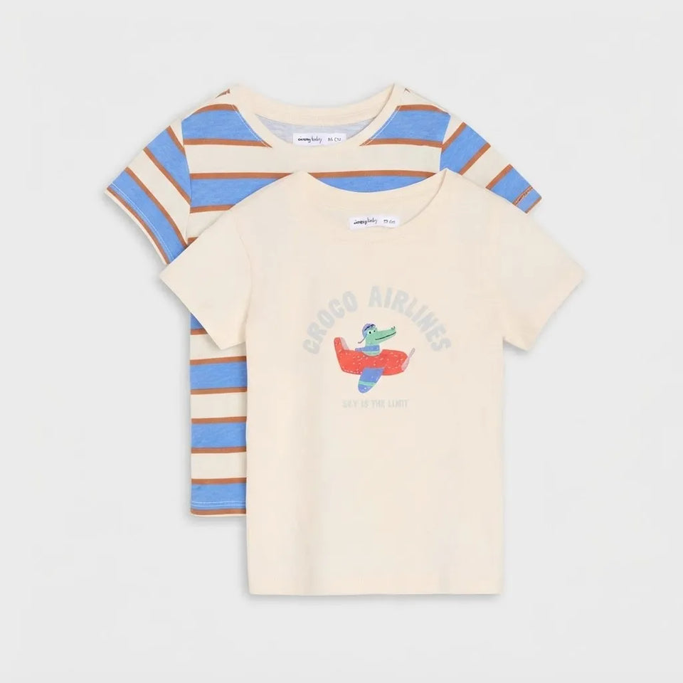 Two children's short-sleeve T-shirts from Comfort Colors laid flat on a light gray background. The front shirt is cream with a colorful 'Crocgo Airlines' graphic, and the back shirt has blue and tan stripes.