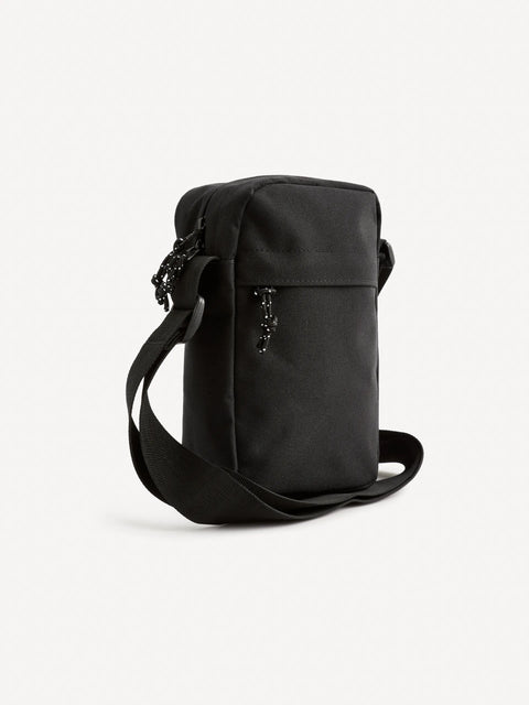 Black crossbody bag with decorative elements on a white background