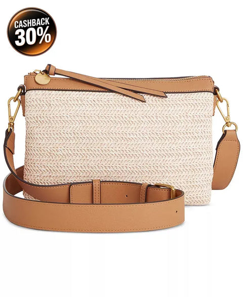 A beige crossbody bag with a straw body and leather details, featuring a shoulder strap and a buckle closure.