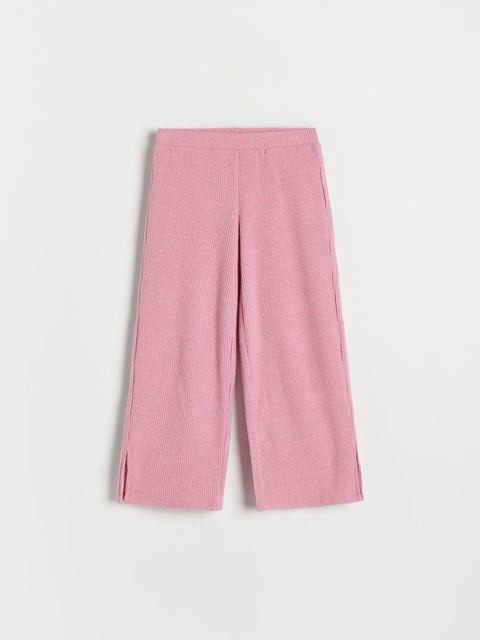 Pink ribbed pants on a light gray background