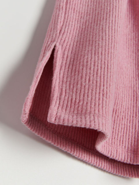 Close-up of a pink textured fabric on a light background