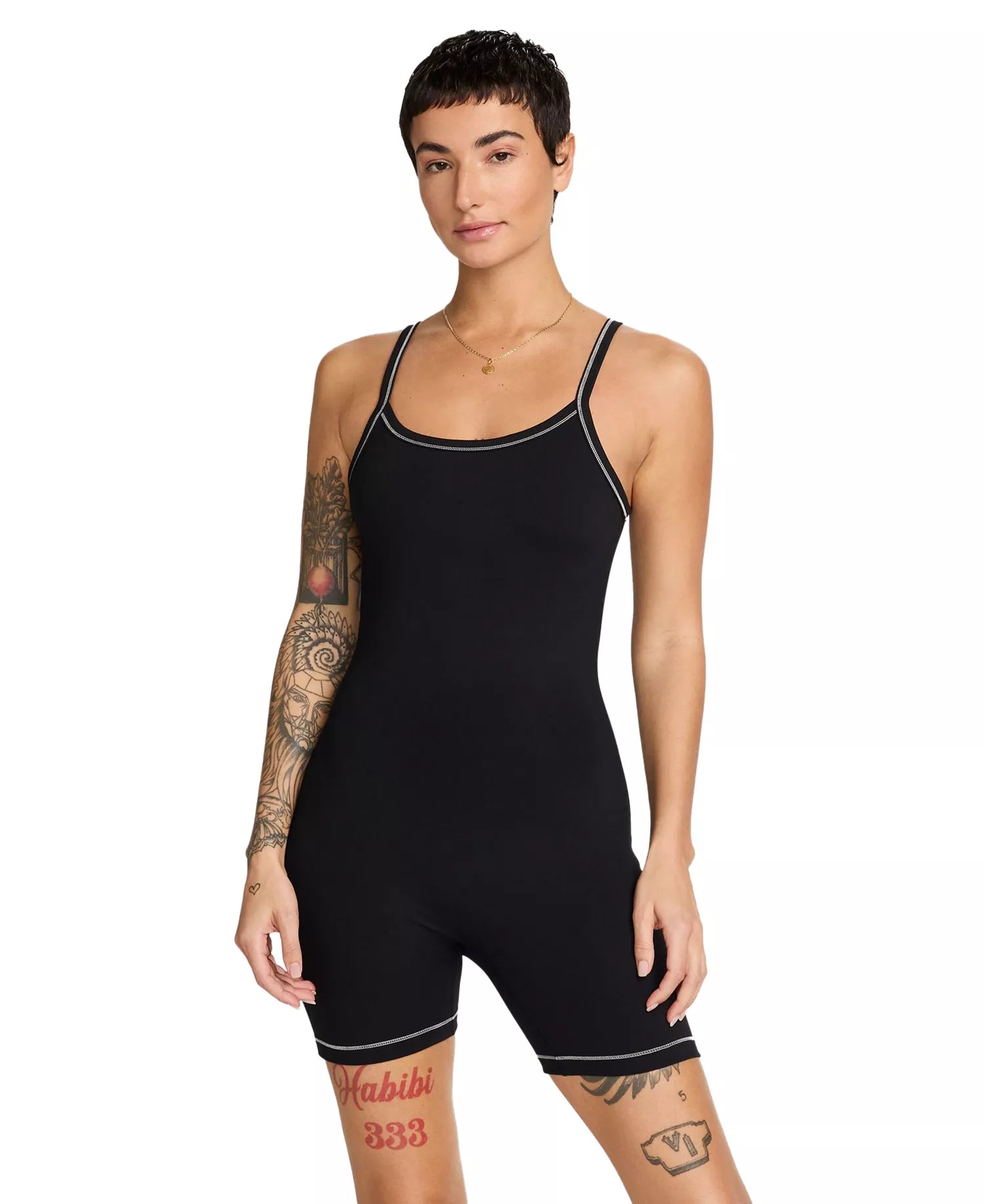 Person wearing a black bodysuit with white trim on a white background