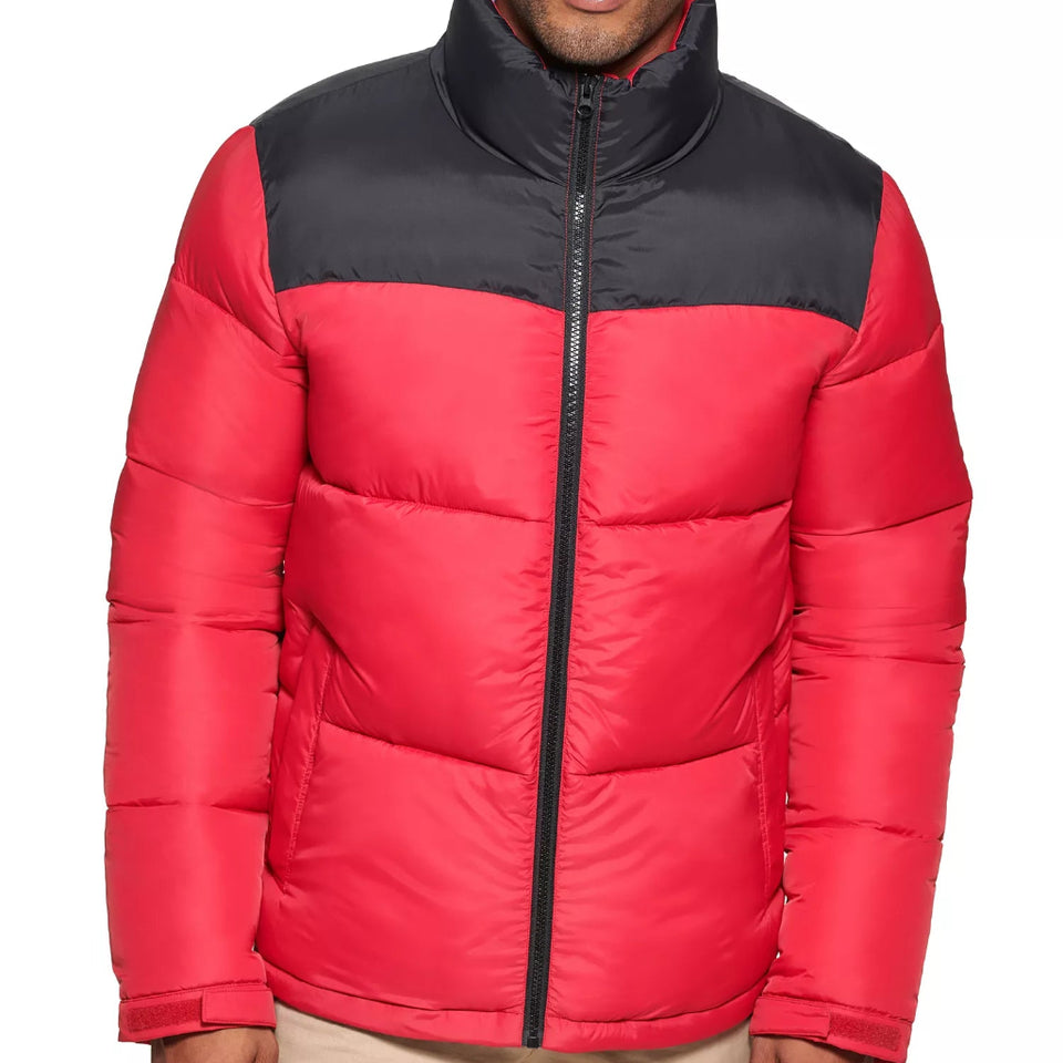 Red and black puffer jacket worn by a person on a white background