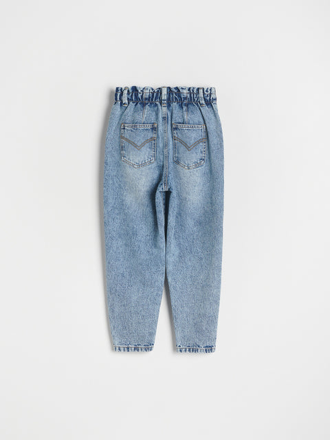 Light blue denim jeans on a white background