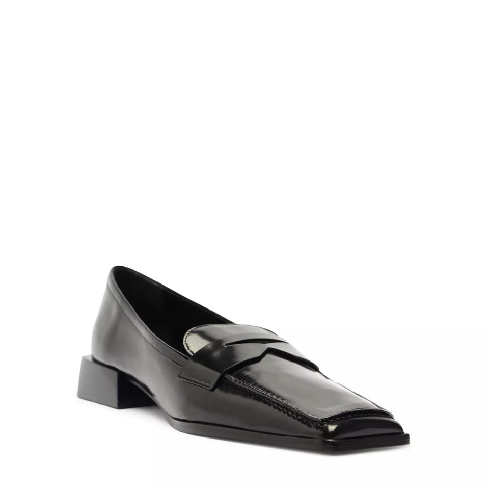 A single black leather penny loafer with a pointed toe and low block heel, shown from a side profile on a white background.