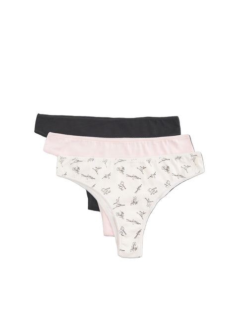 Three pairs of underwear in black, pink, and white with floral pattern on a dark background