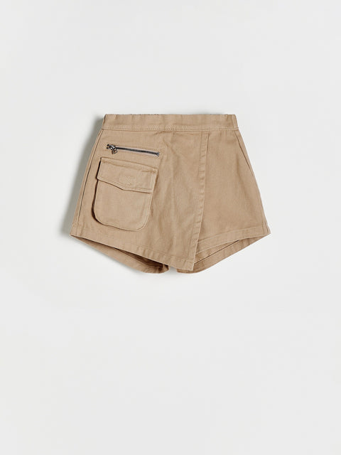 Beige shorts with a zipper pocket on a light beige background