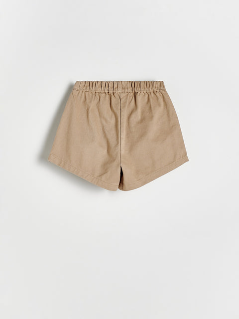 Beige shorts on a light gray background