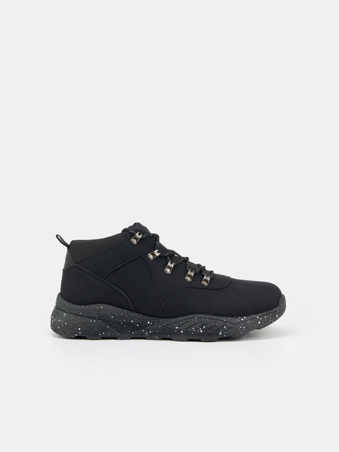 Black hiking boot on a light gray background