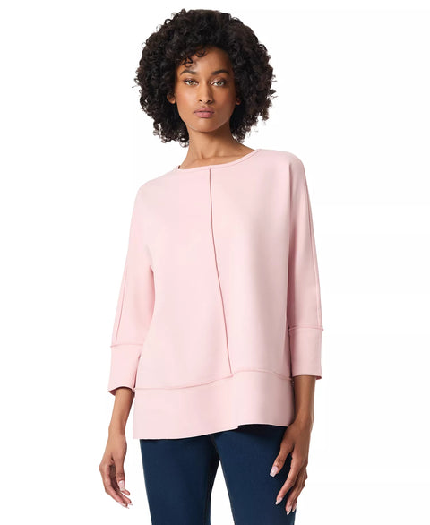 Woman wearing a light pink blouse with a white background