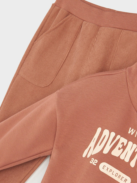 Brown pants with 'ADVENT 32 EXPLORER' text on a white background