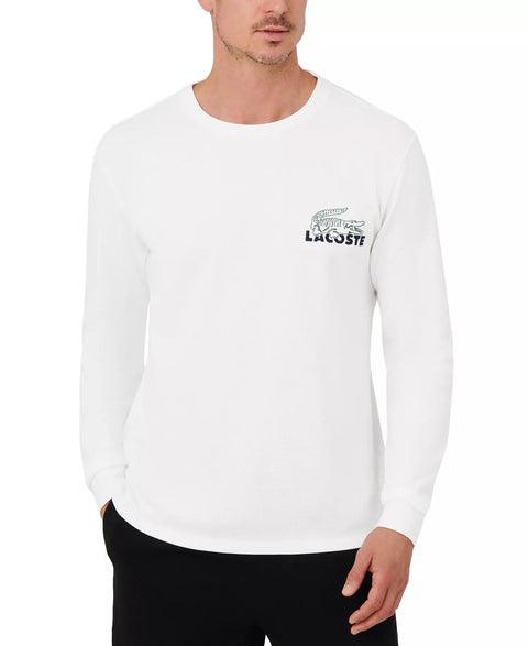 Man wearing a white long-sleeve shirt with a Lacoste logo on a white background
