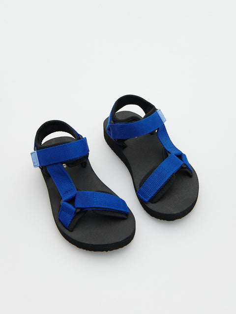 Black sandals with blue straps on a white background