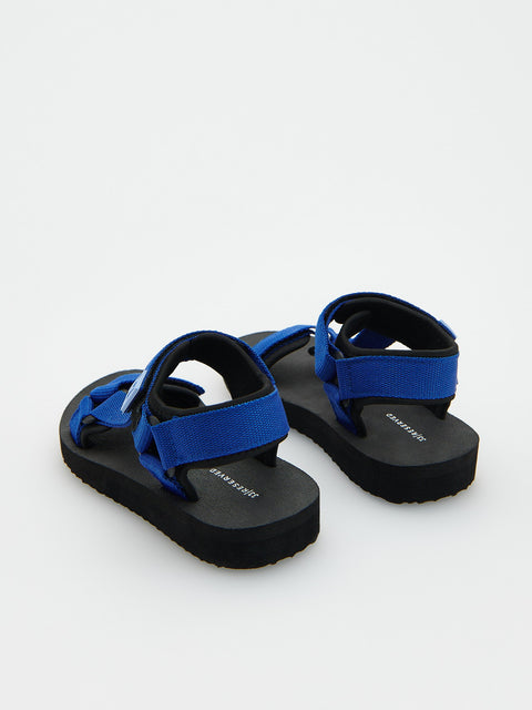Blue sandals with black soles on a white background