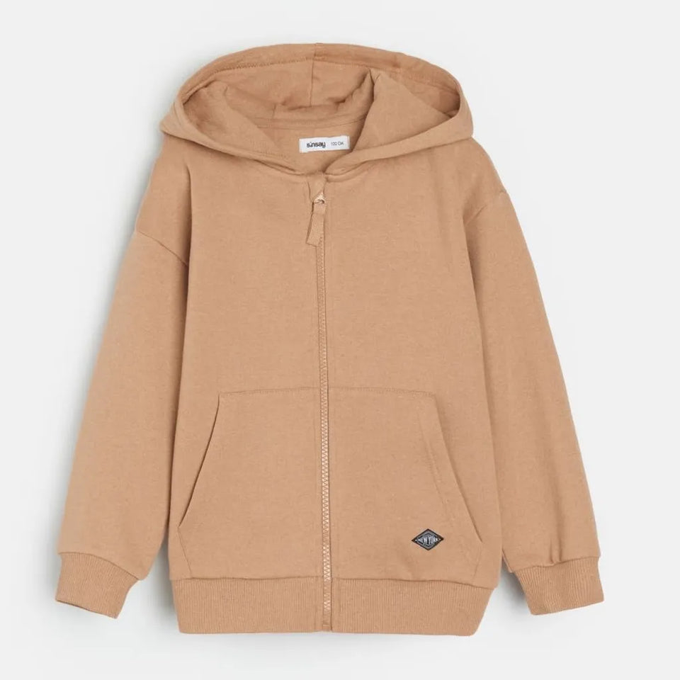 A light brown zip-up hoodie with a drawstring hood, front pockets, and ribbed cuffs and hem, shown against a light gray background.