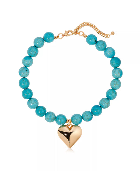 Turquoise beaded necklace with a gold heart pendant on a white background