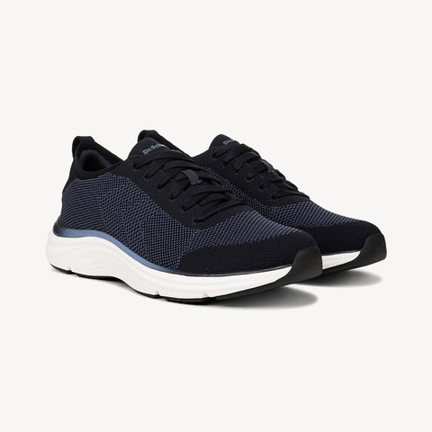 Pair of navy blue sneakers with white soles on a light gray background