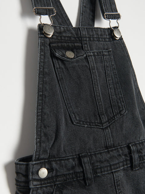 Black denim overalls with suspenders on a white background