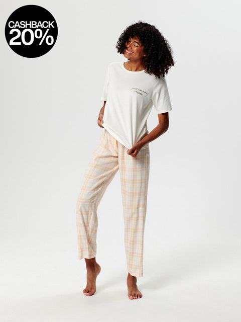 Woman wearing a white top and checkered pants on a white background