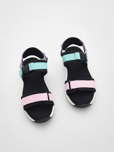 Black sandals with pink and blue straps on a white background