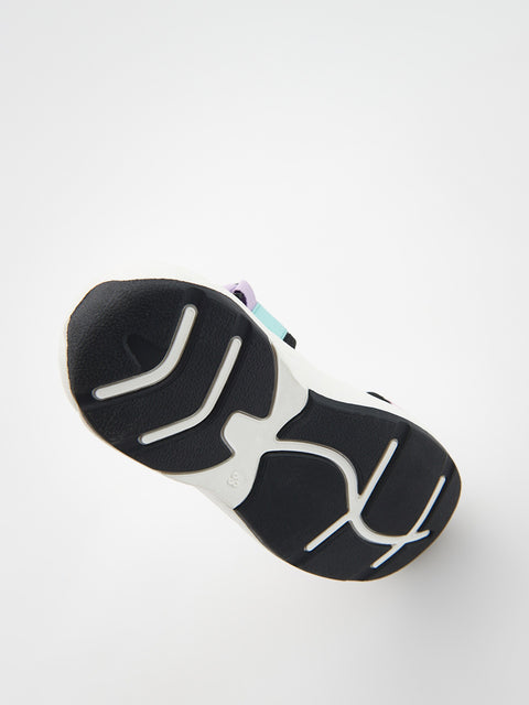 Black and white sole of a shoe on a light gray background