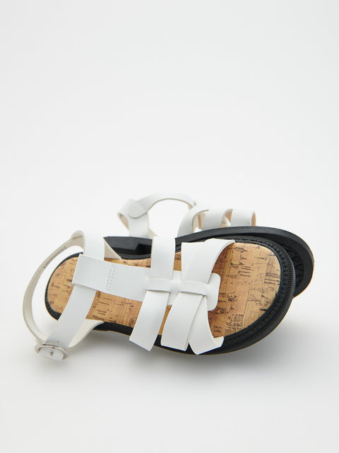 White sandal with cork sole on a white background