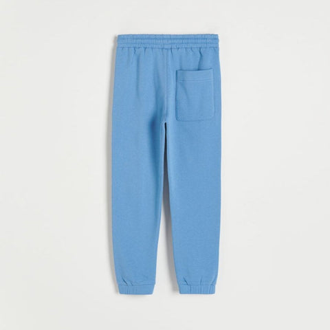Light blue sweatpants on a light gray background