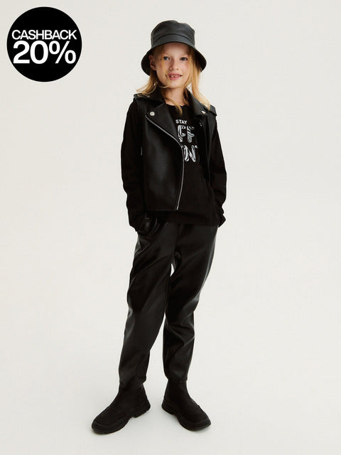 Person wearing a black outfit with a jacket and pants on a white background