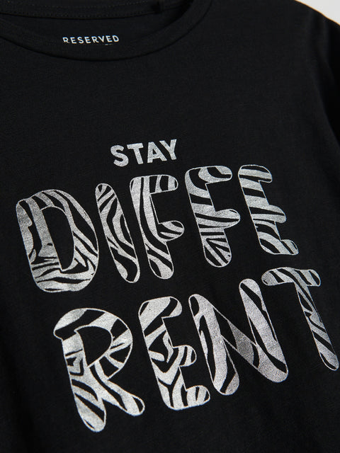 Black t-shirt with 'Stay Different' text in zebra print on a plain background