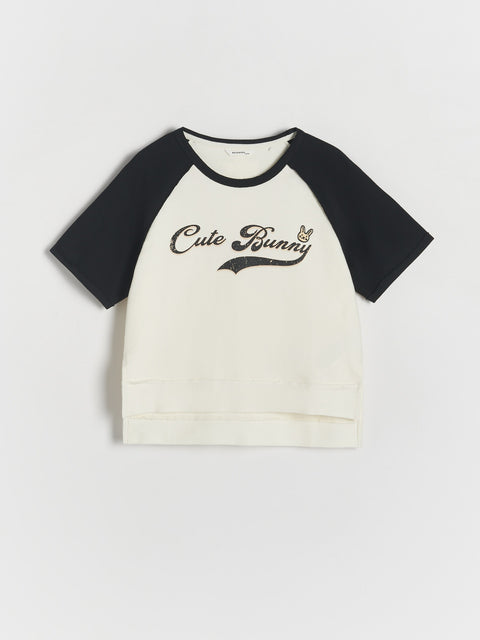 Black and white baseball shirt with 'Cute Bunny' text on a light gray background