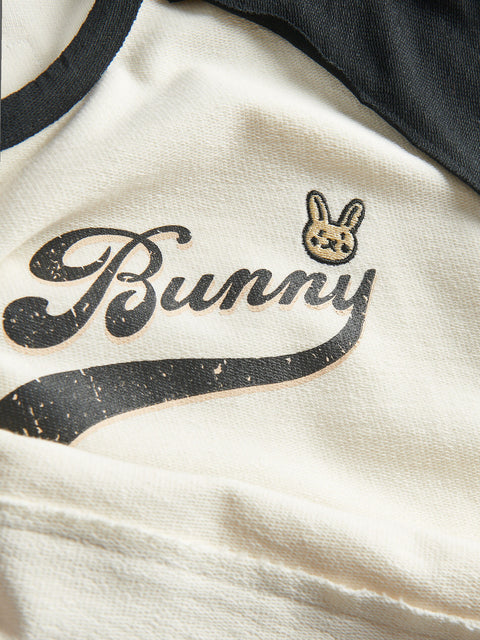 Close-up of a shirt with 'Bunny' logo and text on a beige background