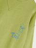 Green sweater with blue graphic design on a white background