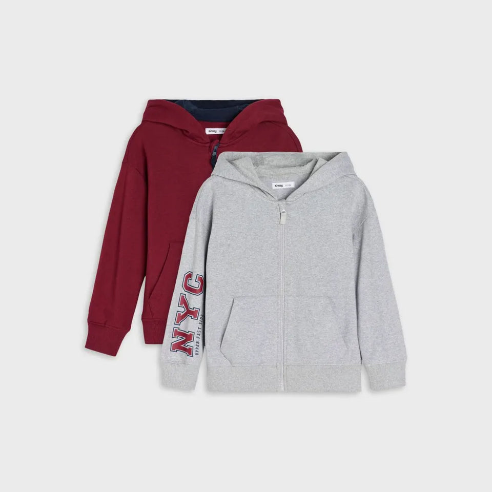 Two hooded zip-up sweatshirts displayed against a light gray background: a heather gray one in front with a vertical 'NYC' graphic on the sleeve, and a burgundy one behind.