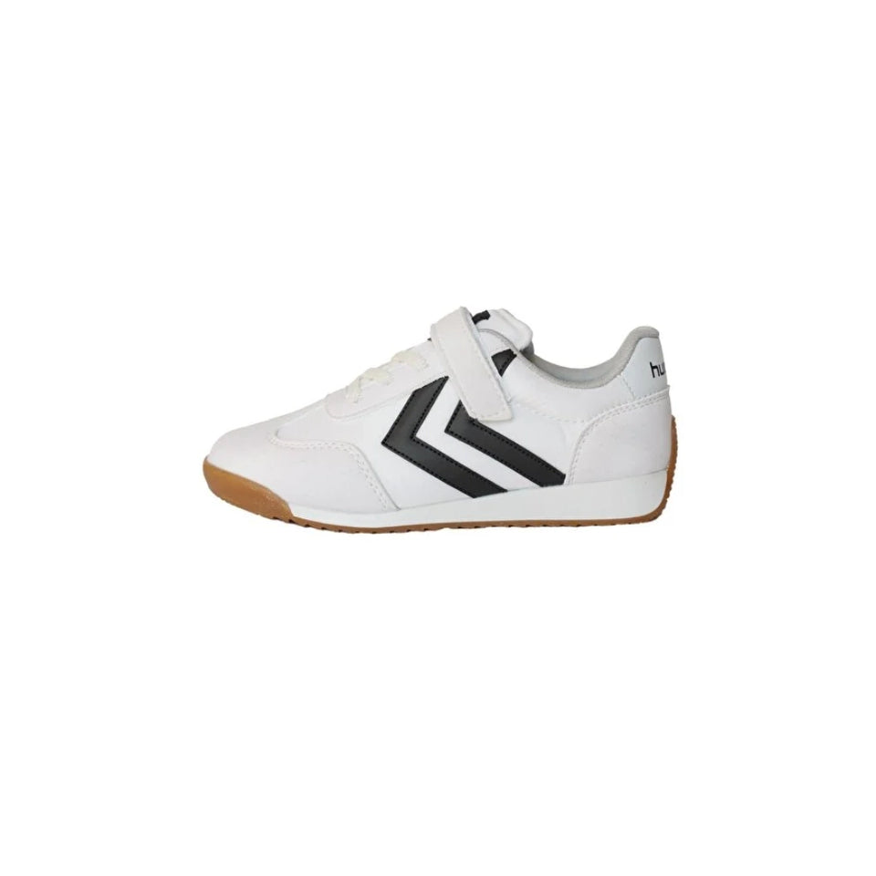 A white low-top sneaker with a black chevron logo on the side, a hook-and-loop strap closure, and a brown gum outsole, shown against a plain white background.