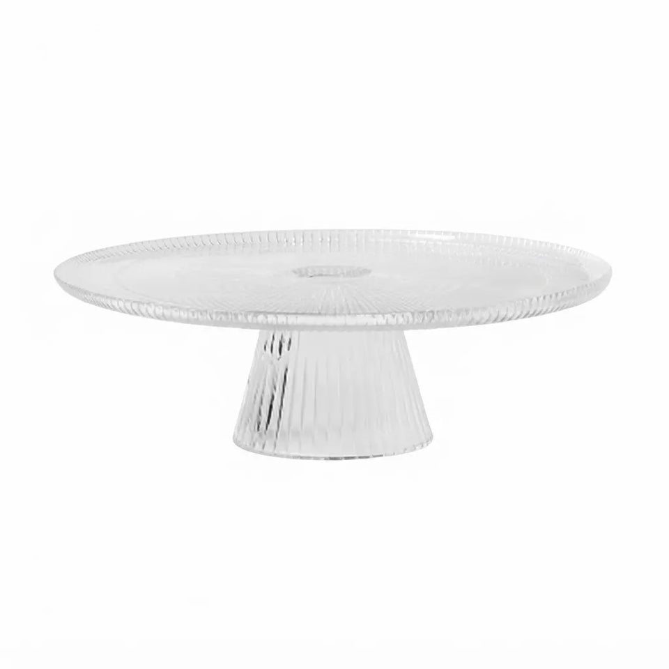 A round, clear glass cake stand with a fluted pedestal base, shown against a plain white background.