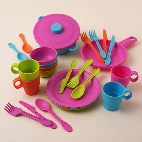 Colorful children's plastic dinnerware set on a beige background