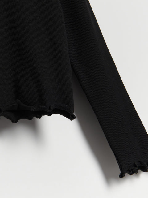 Black long-sleeve top with ruffled hem on a white background