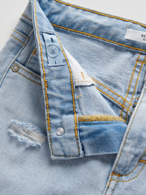 Close-up of a light blue denim jacket with stitching details