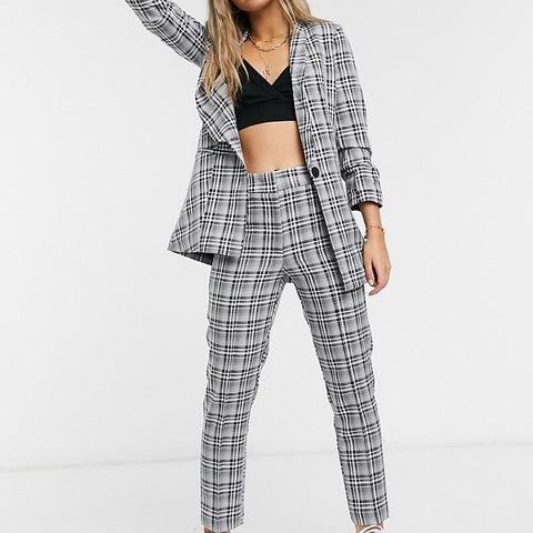 Person wearing a plaid suit with a white background