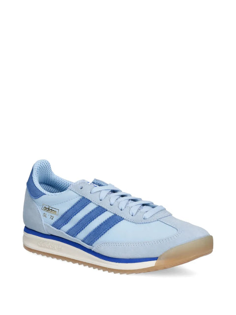 Light blue Adidas sneaker with three stripes on a white background
