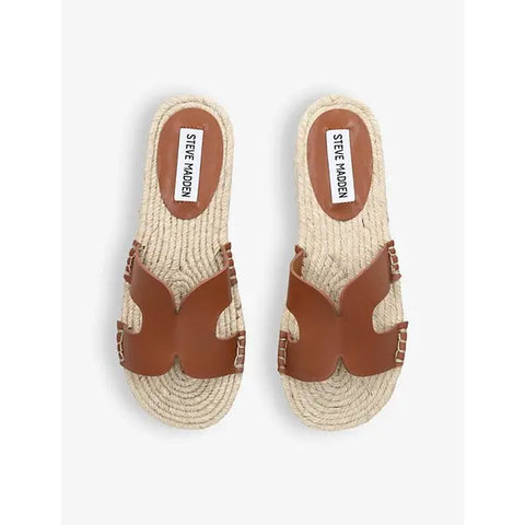 Pair of Steve Madden sandals with woven design and brown leather straps on a white background