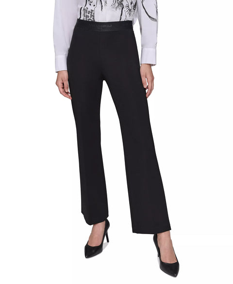 Black pants worn by a person on a white background